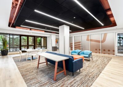 View of indoor lounge with terrace access, including open tables and comfy seating.