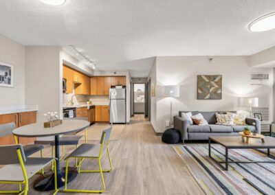 View of common area in a 4-bedroom apartment including a large living room, dining area, and open-concept kitchen.